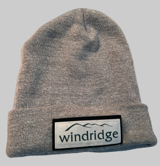 Light grey knitted acrylic wool winter beanie hat with 'windridge' logo patch on the front.